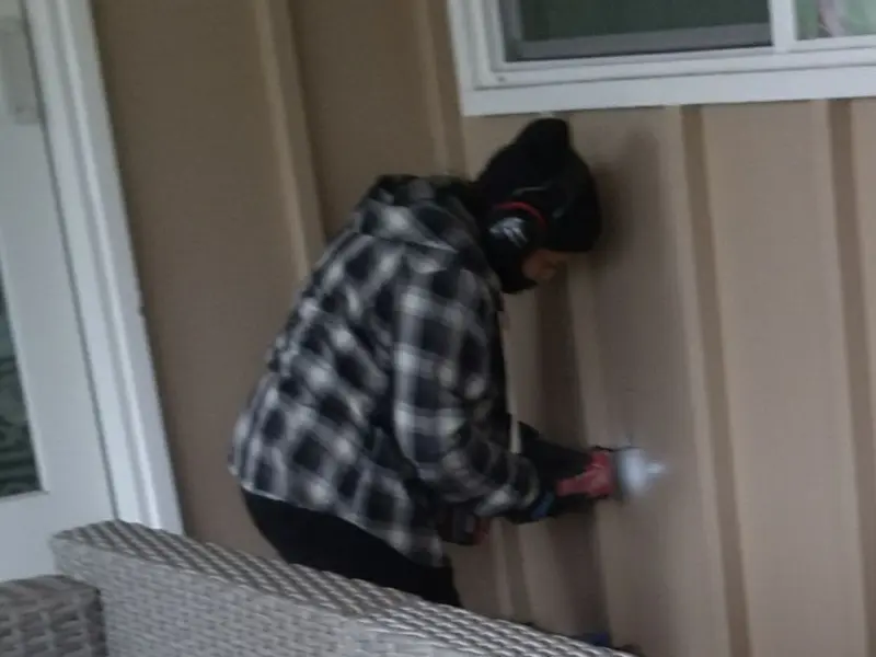 Professional electrician installing an exterior outlet in Spanaway