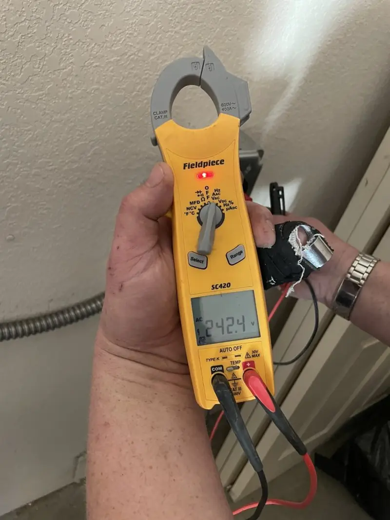 Voltage testing with clamp meter during Recessed Lighting Installation in Spanaway